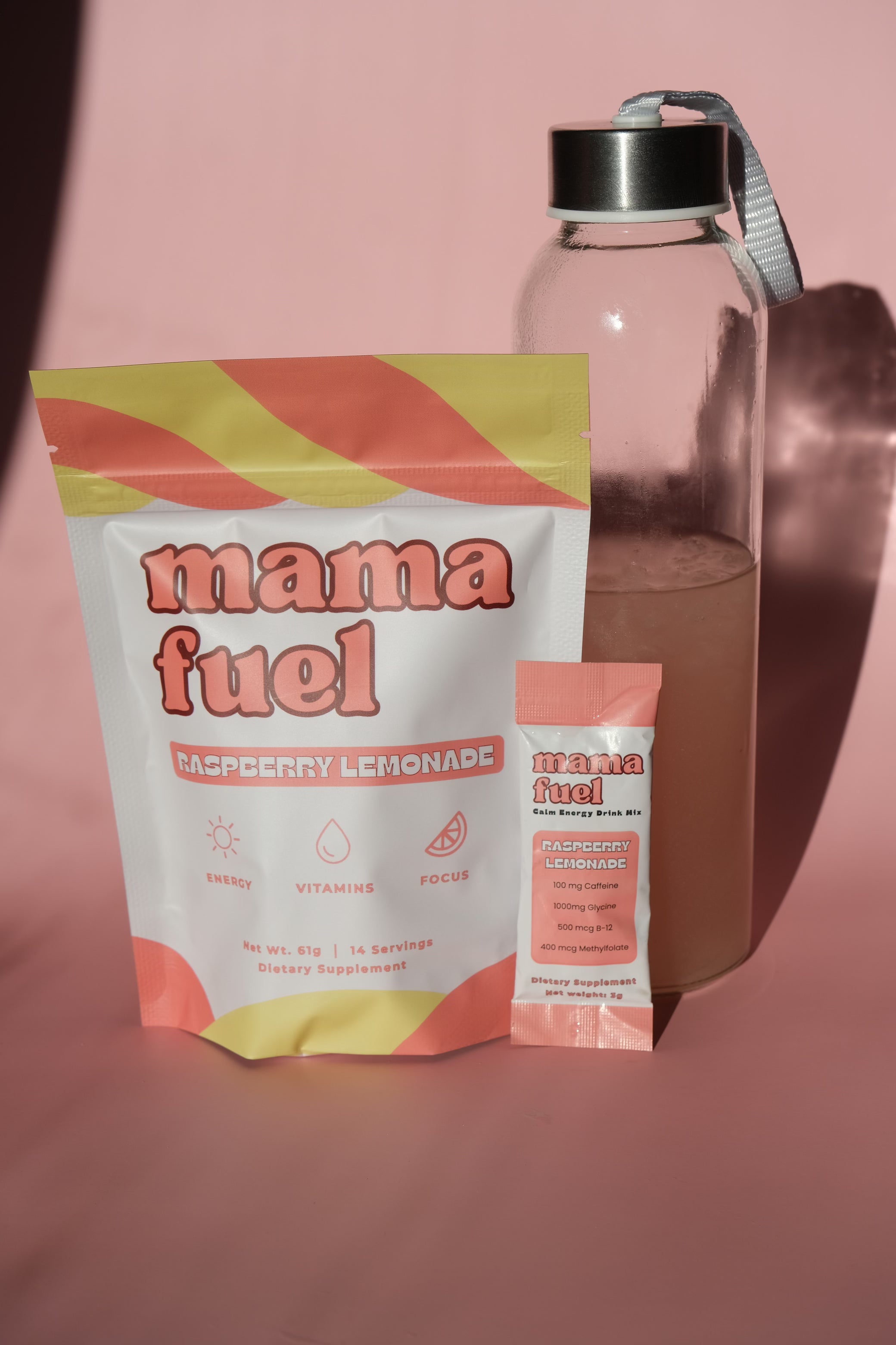 Mama Fuel raspberry lemonade package with a water bottle on a pink background